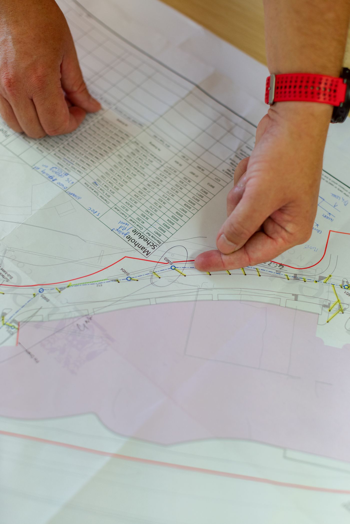 A civil engineer reviews a technical drawing.