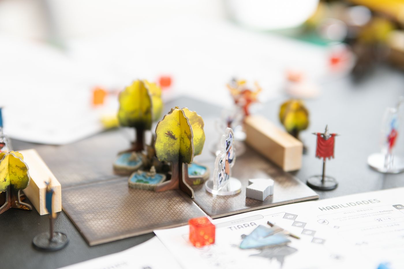 Miniature figures and dice form a tabletop role-playing game scene.