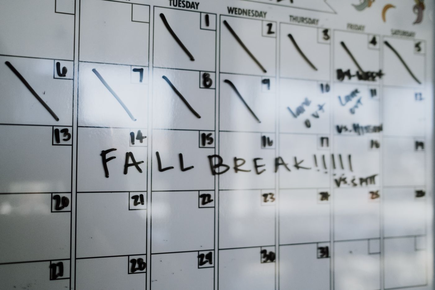 A whiteboard calendar has FALL BREAK written across one week.