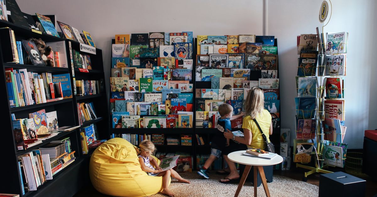 A family reads together in a colorful library.