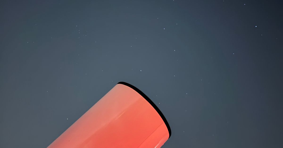 A telescope points into a clear night sky.