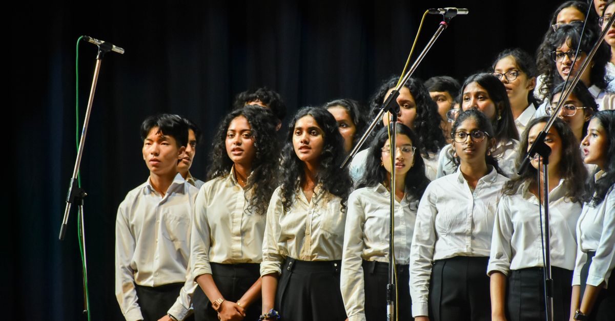A choir performs together onstage.