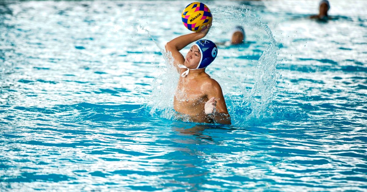 Water polo players compete in a pool.