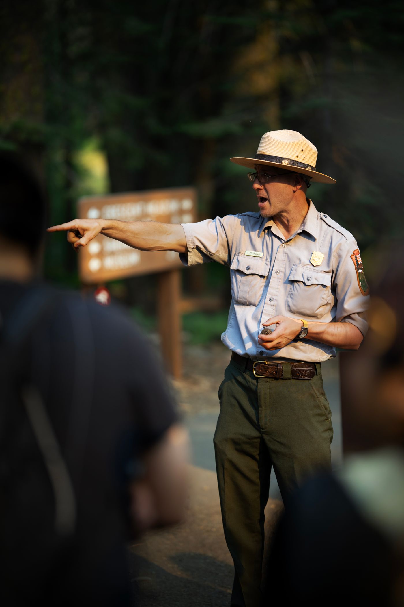 A park ranger speaks to a small group outdoors.